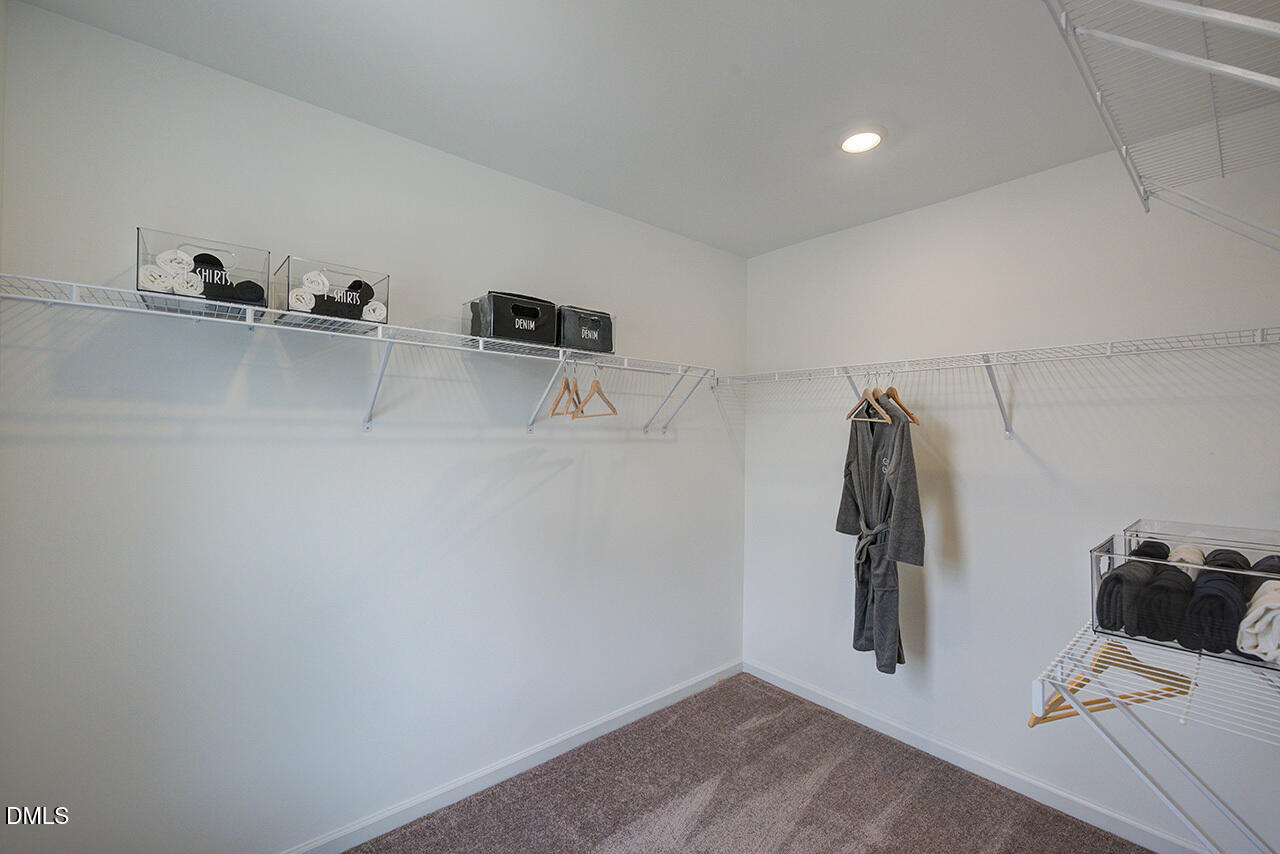 51 Shay Street Angier, NC 27501 - Photo 19 of 41 a view of walk in closet with clothes and shoes