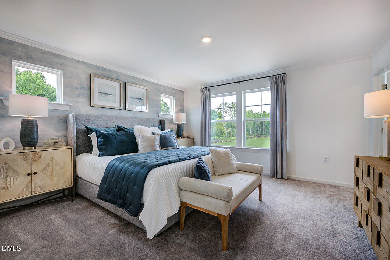 51 Shay Street Angier, NC 27501 - Photo 20 of 41 a spacious bedroom with a bed and a couch