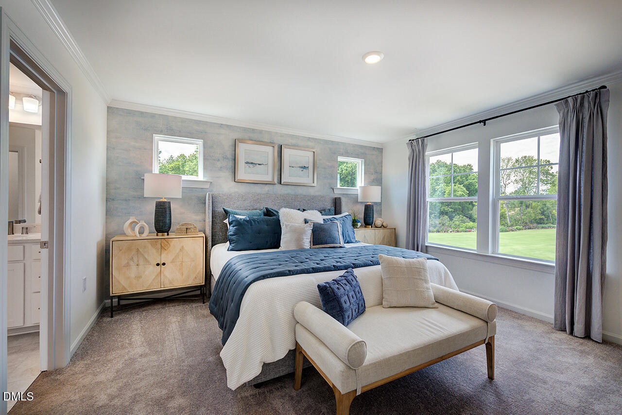 51 Shay Street Angier, NC 27501 - Photo 22 of 41 a spacious bedroom with a bed and a couch