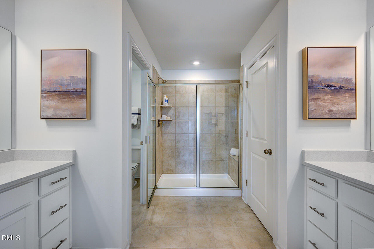 51 Shay Street Angier, NC 27501 - Photo 25 of 41 a bathroom with a shower sink and mirror