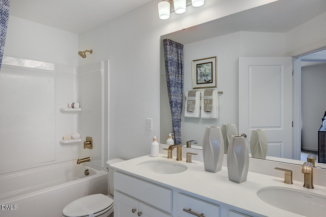 51 Shay Street Angier, NC 27501 - Photo 30 of 41 a bathroom with a granite countertop toilet sink and a mirror