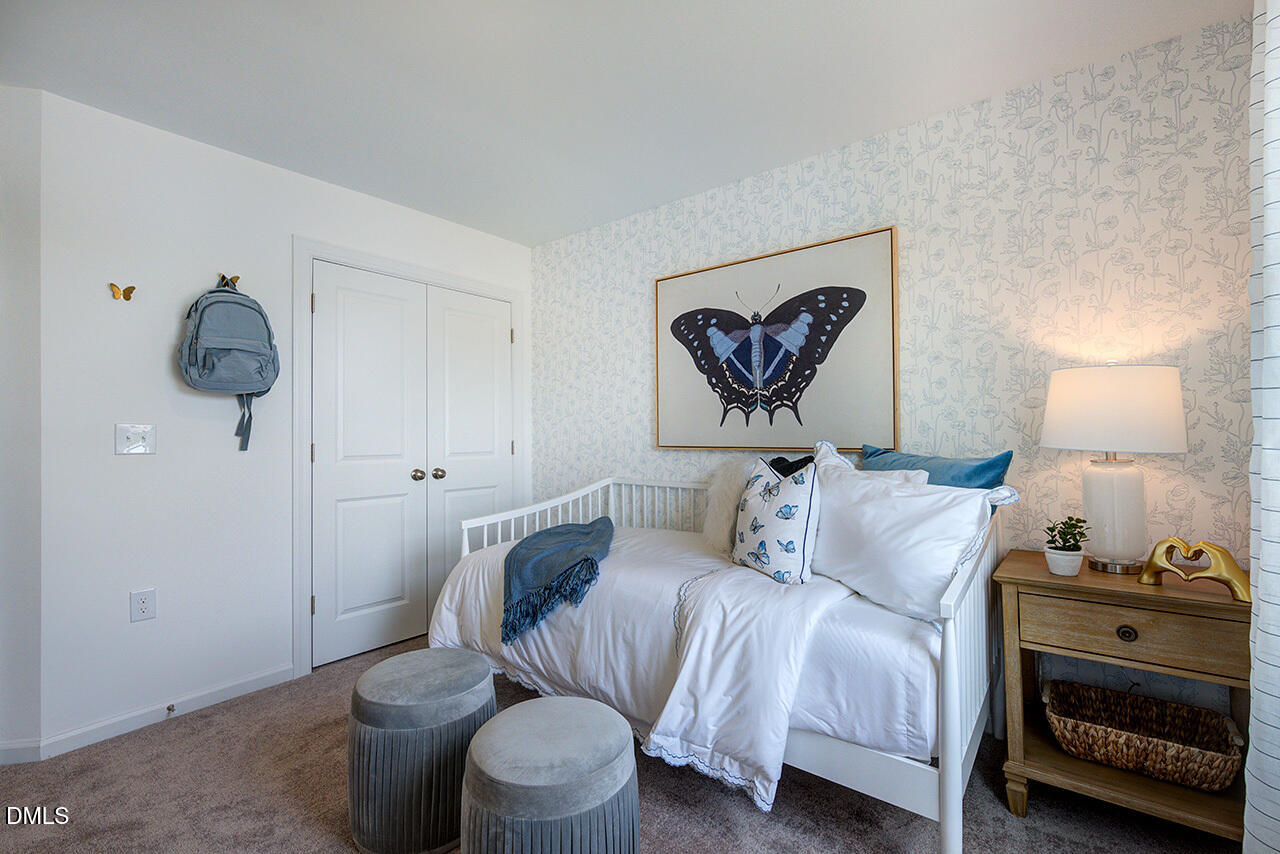 51 Shay Street Angier, NC 27501 - Photo 32 of 41 a bedroom with a bed and a painting on the wall