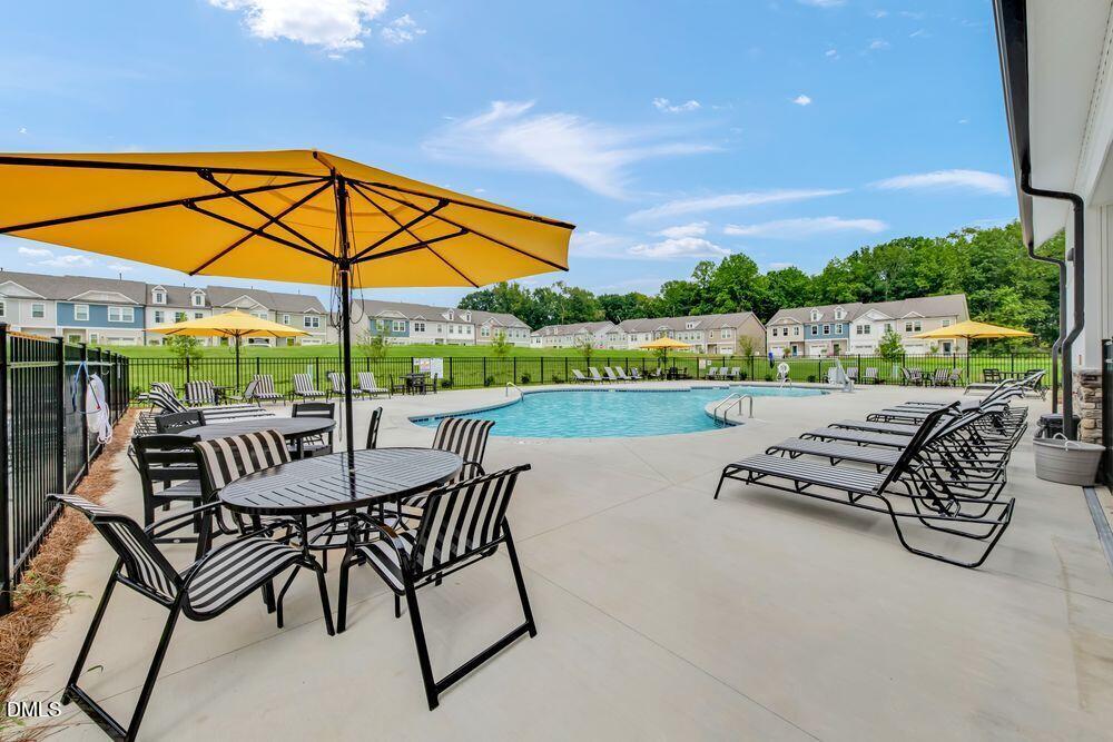 51 Shay Street Angier, NC 27501 - Photo 36 of 41 a view of patio with table and chairs under an umbrella with a small yard