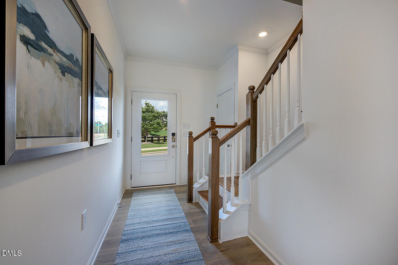 51 Shay Street Angier, NC 27501 - Photo 5 of 41 a view of a hallway with wooden floor and staircase