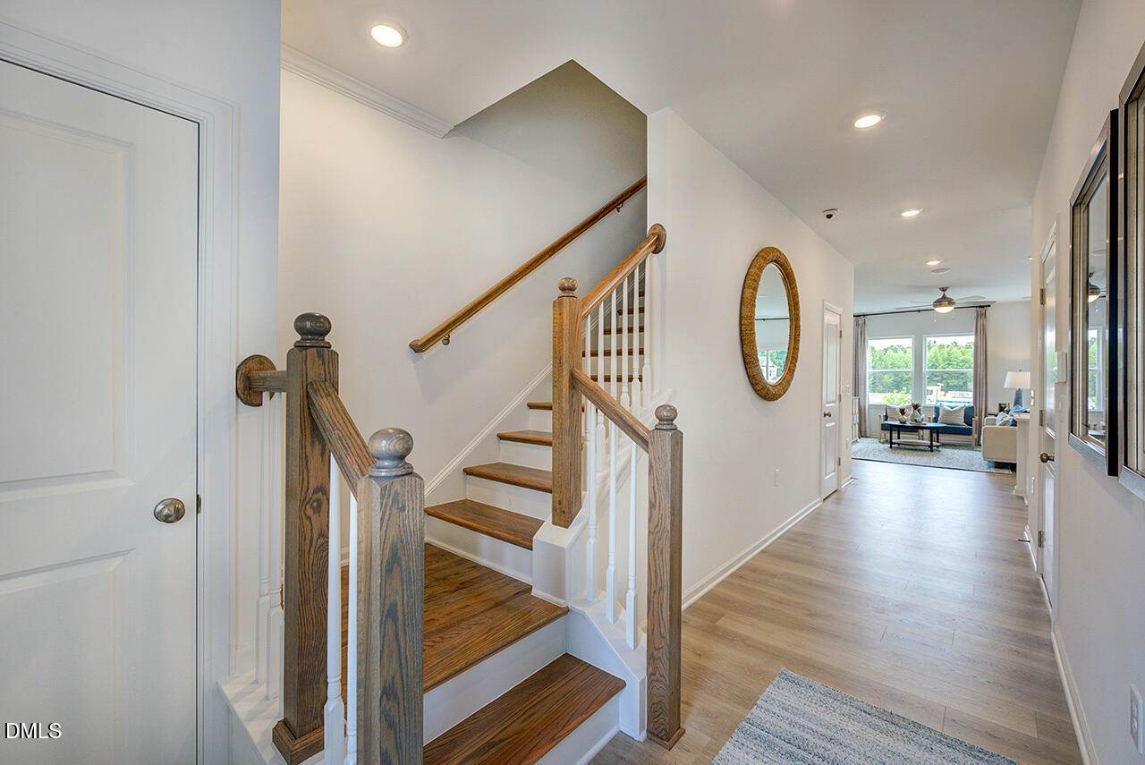 51 Shay Street Angier, NC 27501 - Photo 6 of 41 a view of a hallway view with wooden floor and staircase