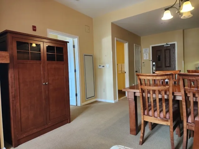 a view of a dining room with furniture and chandelier