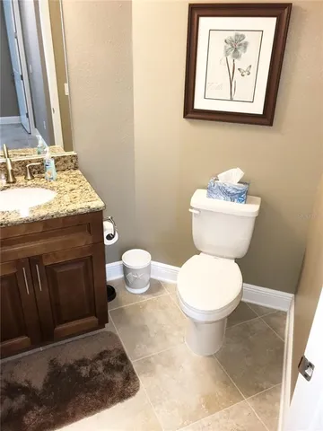 a bathroom with a toilet a sink and a mirror
