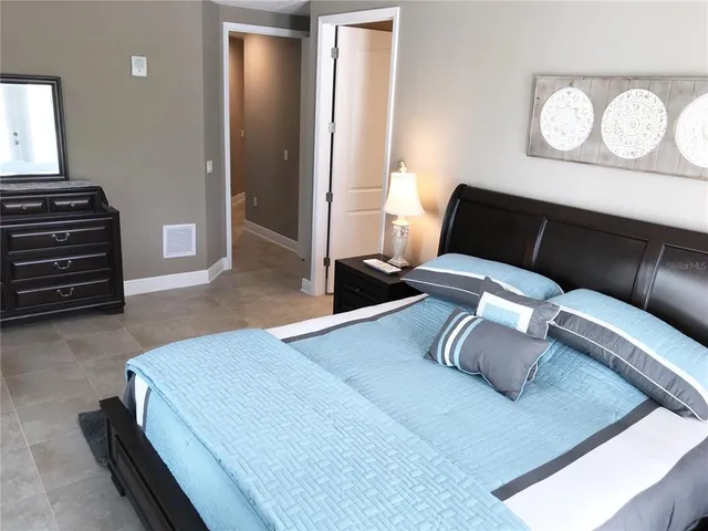a bedroom with a bed and dresser