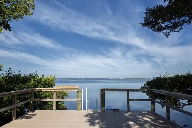 a wooden bench sitting next to a lake