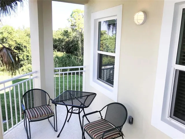 a view of a balcony with furniture and a window