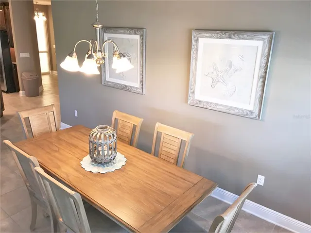 a view of a dining room with a table and chairs