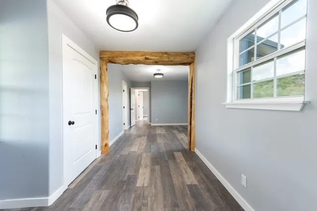 a view of a room with wooden floor cabinet and windows