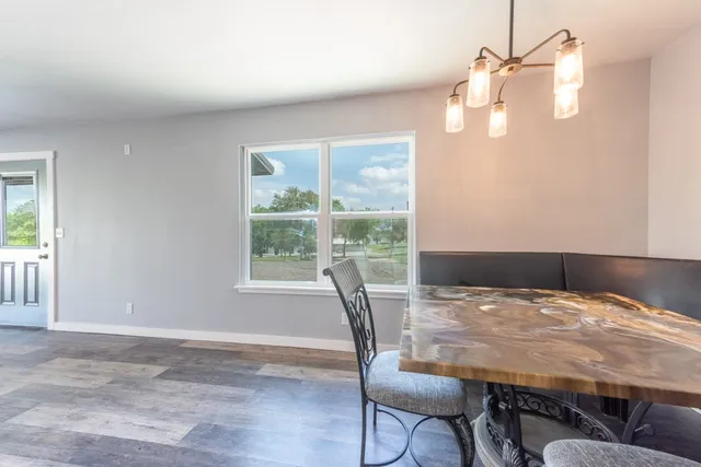 a view of a dining room with furniture window and outside view