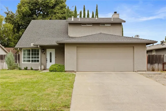a front view of a house with a garden and garage