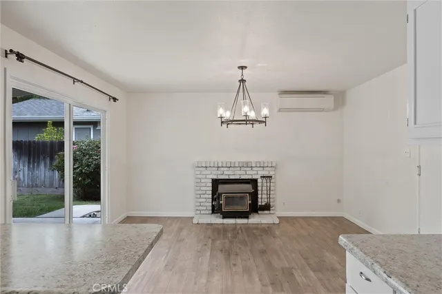 an empty room with fireplace and wooden floor
