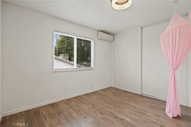 a view of a room with wooden floor and white walls