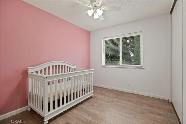 a view of a bedroom with wooden floor