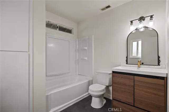 a bathroom with a toilet a sink and bathtub