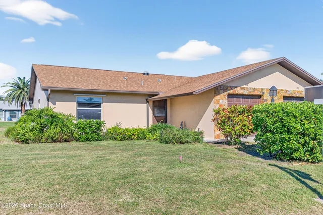a house that has a tree in front of it