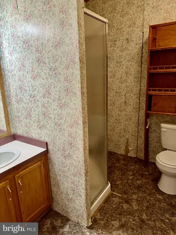 a bathroom with a toilet and a shower