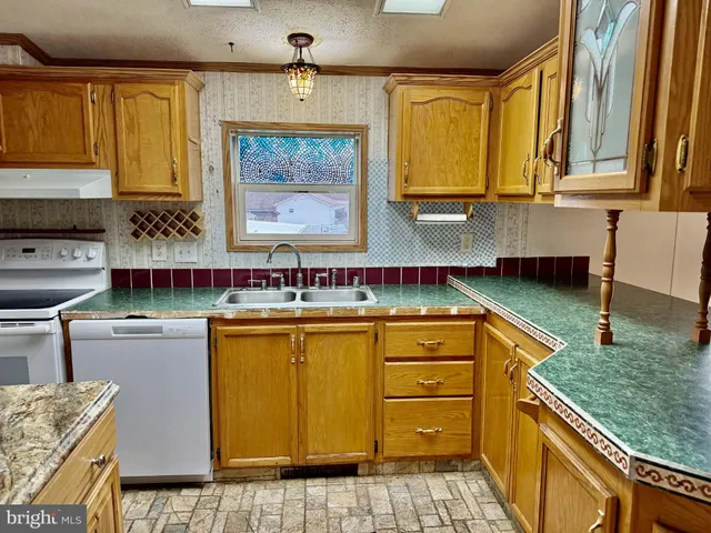 a kitchen that has a sink and a stove in it