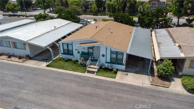 an aerial view of a house with a yard and potted plants