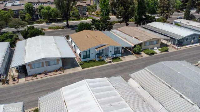 an aerial view of a house with a yard and sitting area