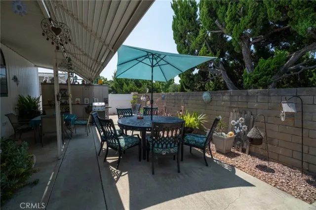 a view of a tables and chairs under an umbrella