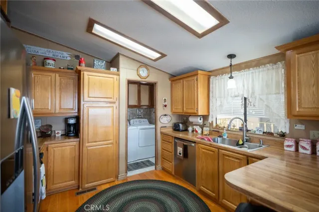 a kitchen with stainless steel appliances granite countertop a refrigerator and a stove