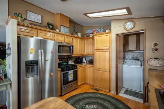 a kitchen with sink refrigerator and large window