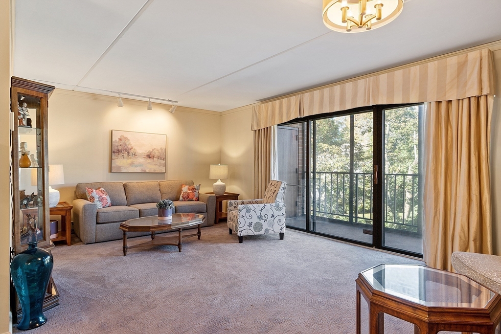 a living room with furniture and a floor to ceiling window