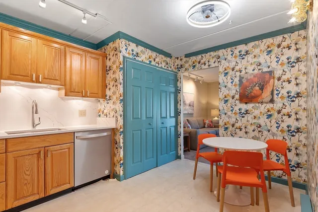 a kitchen with a sink cabinets and window