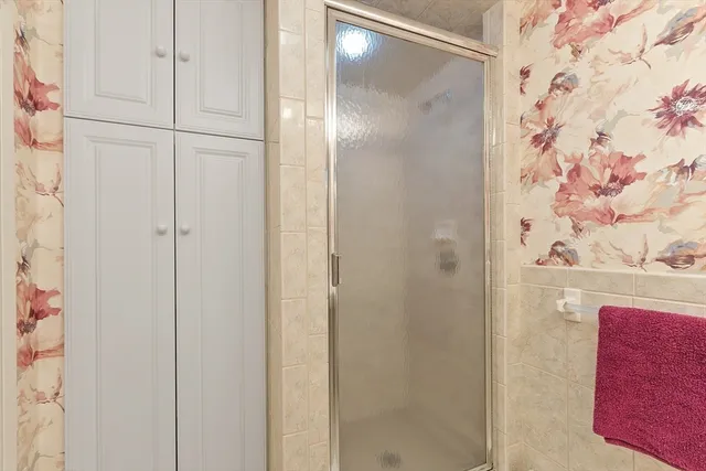 a bathroom with a glass shower door
