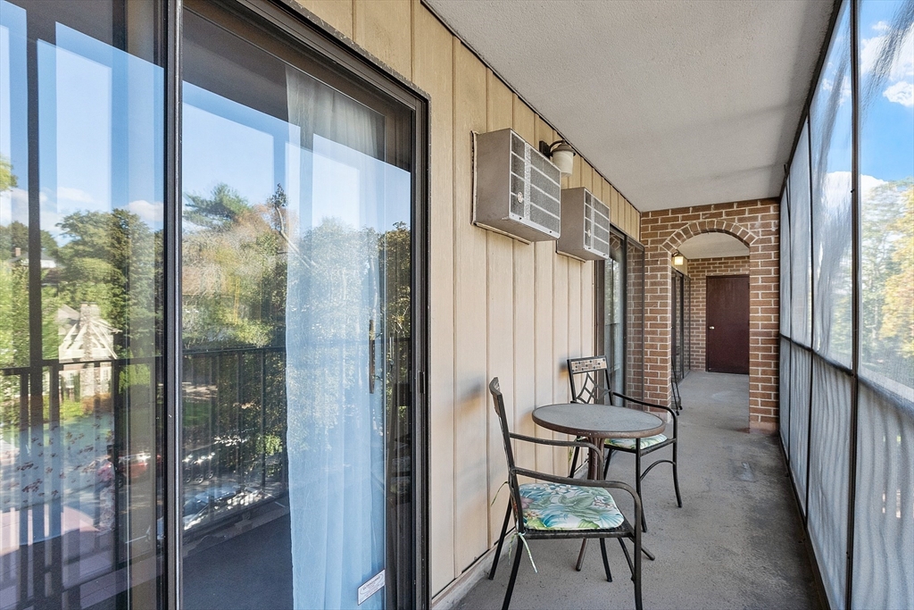 190 High Street, Unit 605 Medford, MA 02155 - Photo 25 of 37 a view of a balcony with chairs and a table in the balcony