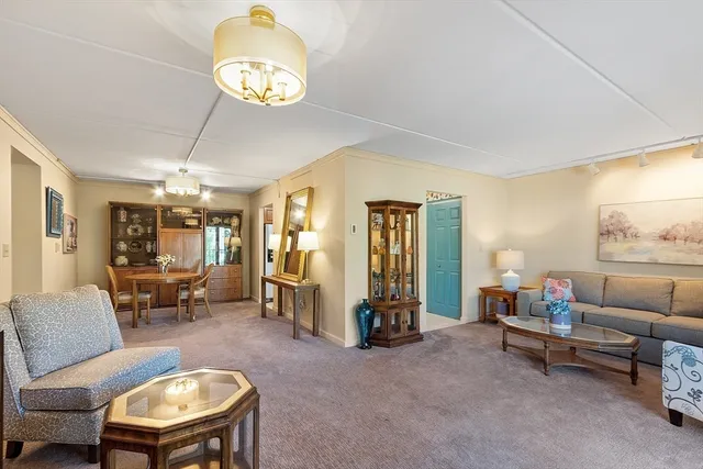 a living room with furniture and a chandelier