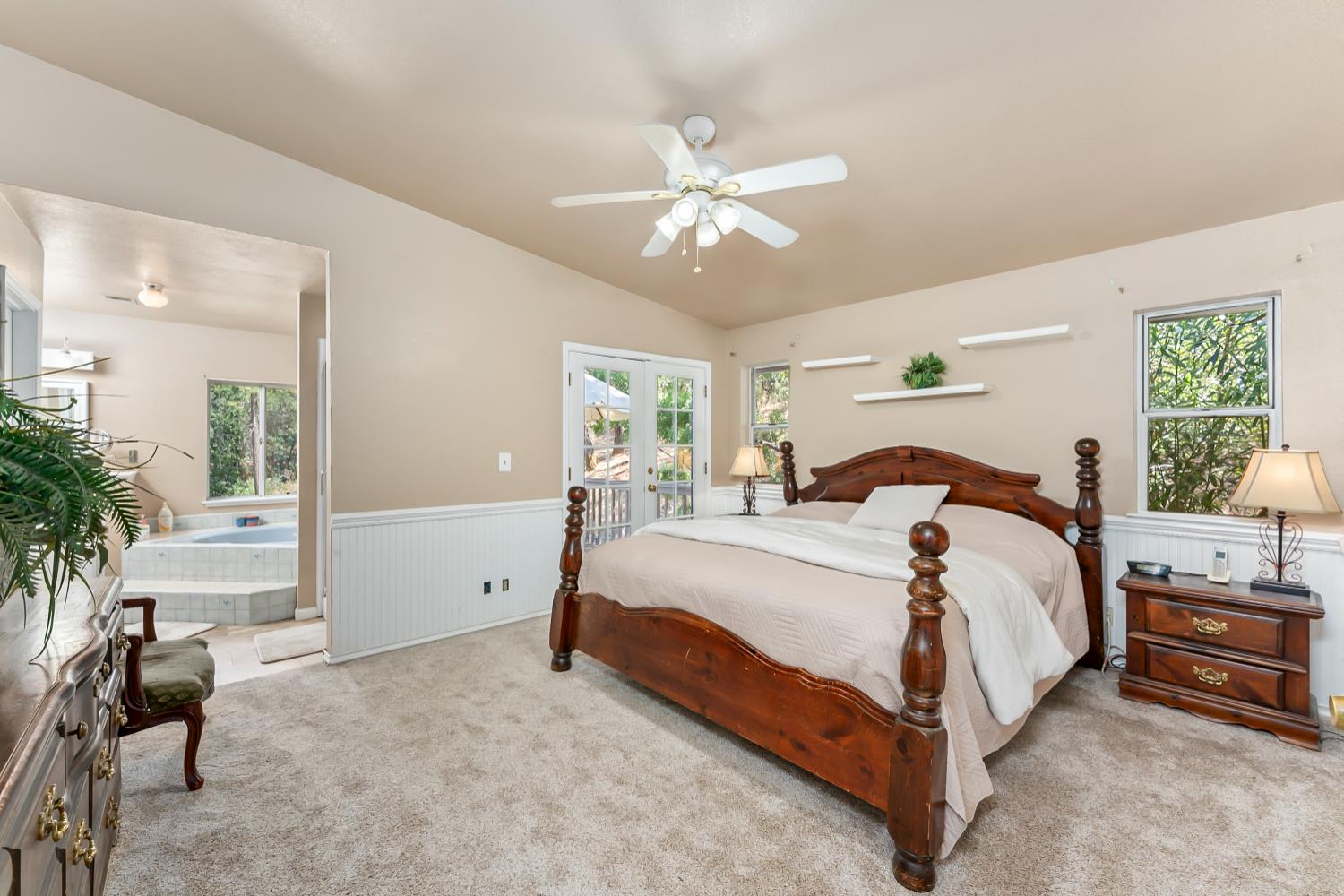 3472 See View Court Rescue, CA 95672 - Photo 31 of 56 a bedroom with a bed and a chandelier