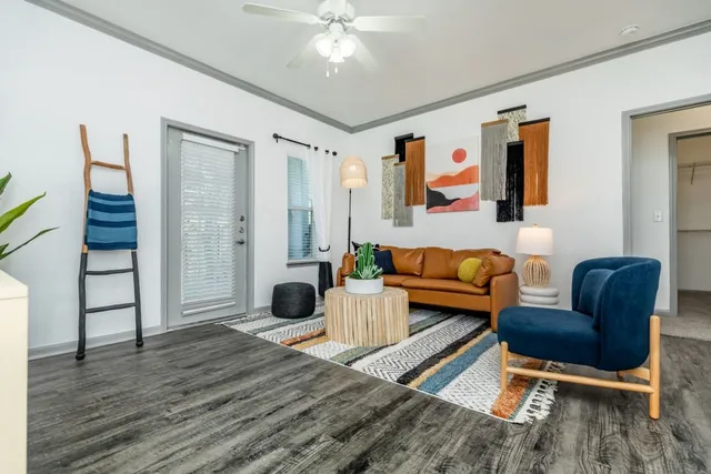 a living room with furniture and wooden floor