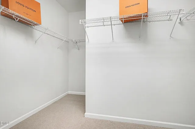 a bedroom with a large bed and a potted plant