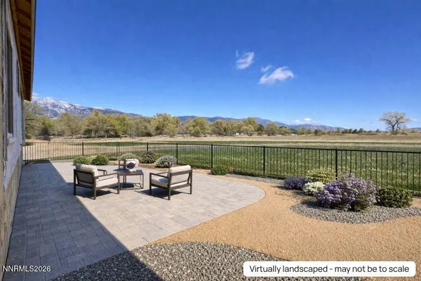 a view of a lake with couches in front of house