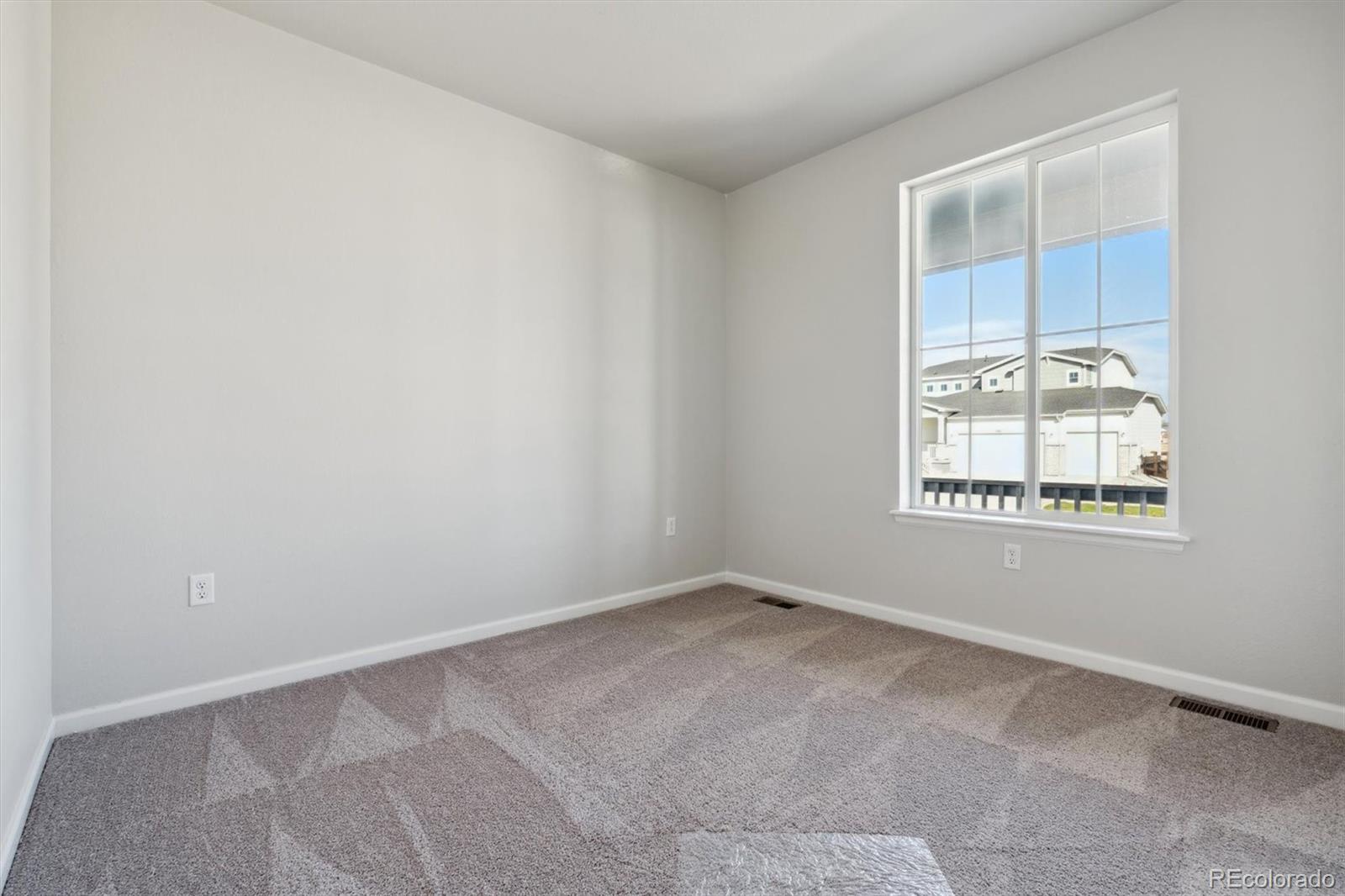 4264 Gozzer Ranch Drive Elizabeth, CO 80107 - Photo 12 of 21 an empty room with windows