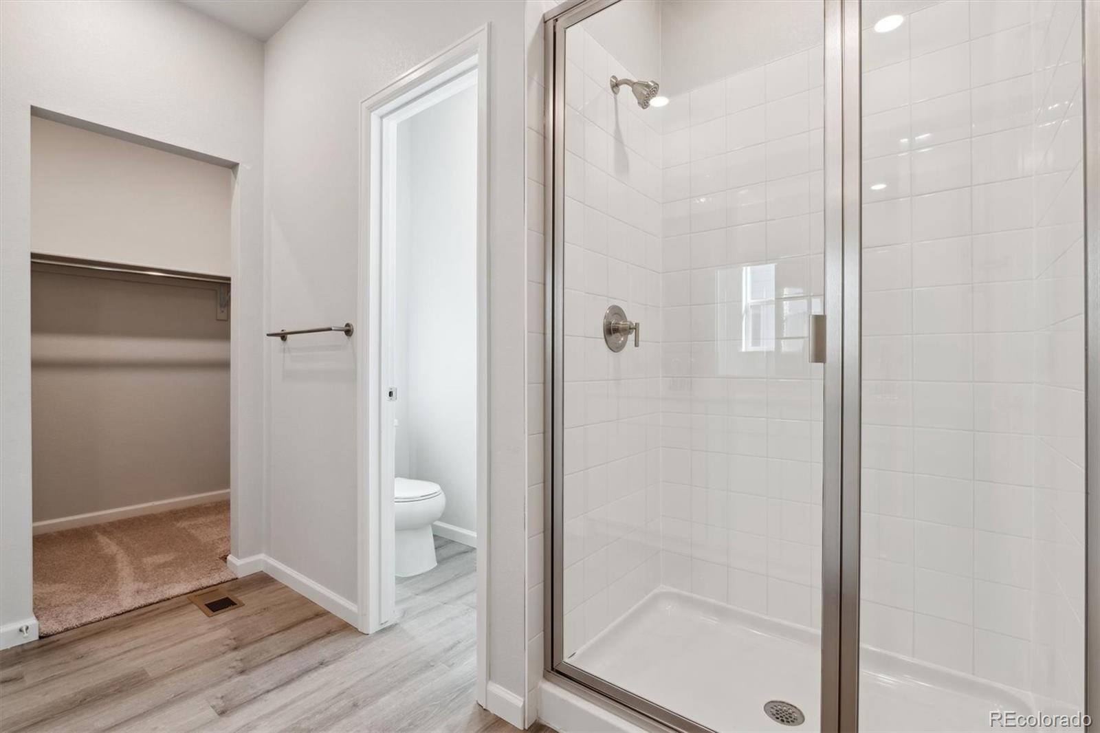 4264 Gozzer Ranch Drive Elizabeth, CO 80107 - Photo 20 of 21 a bathroom with a shower and a glass door