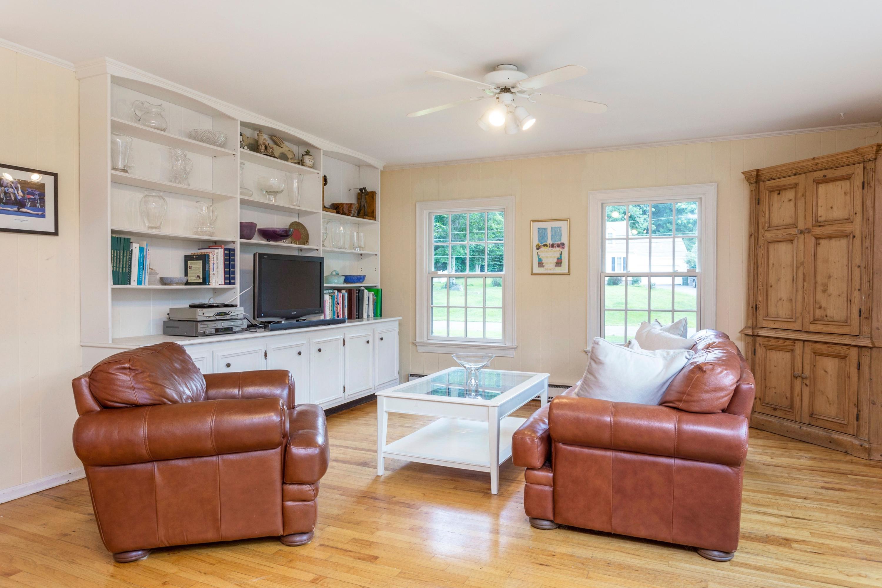 34 Country Club Road Darien, CT 06820 - Photo 11 of 17 a living room with furniture a flat screen tv and a window