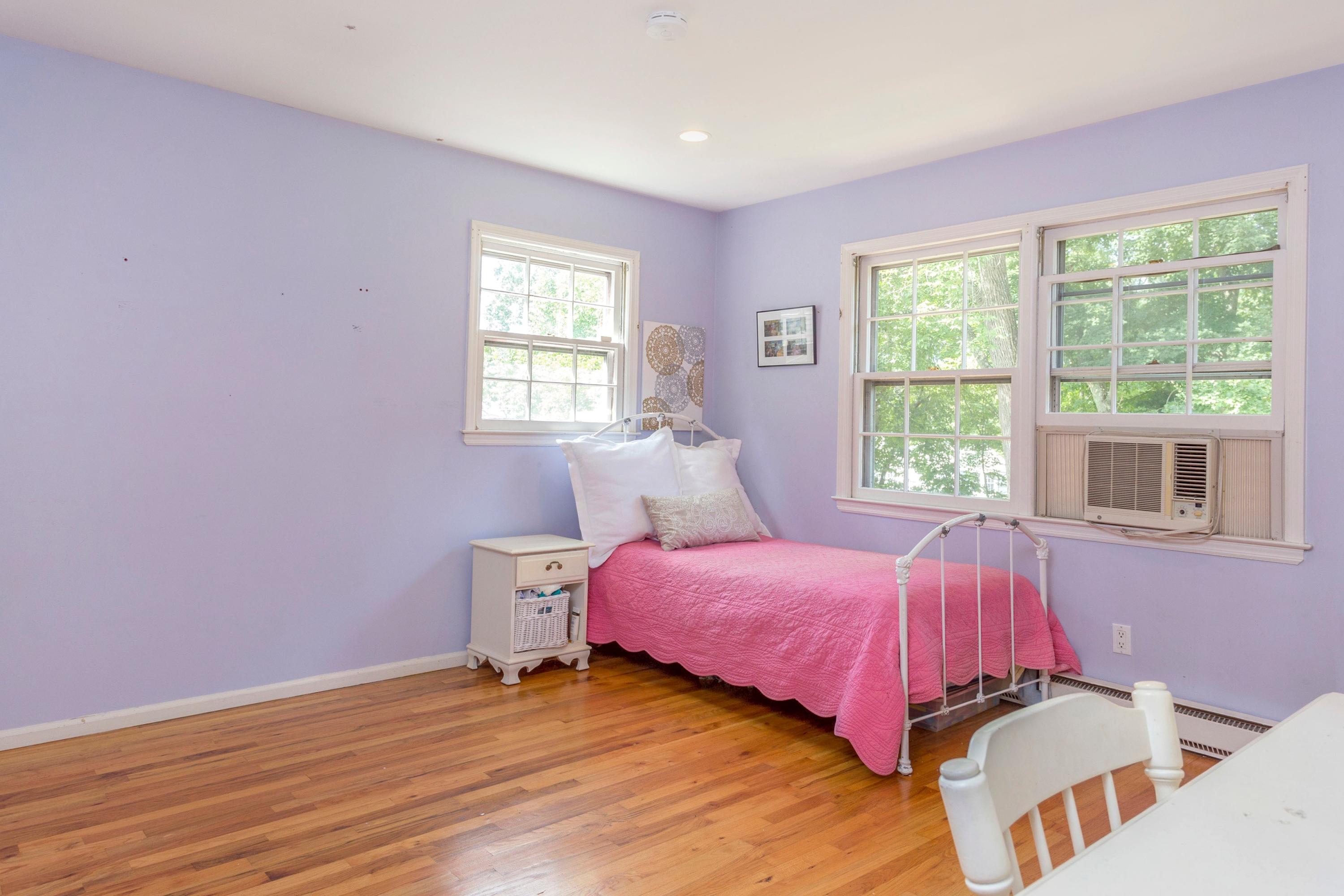 34 Country Club Road Darien, CT 06820 - Photo 14 of 17 a bedroom with a bed and wooden floor
