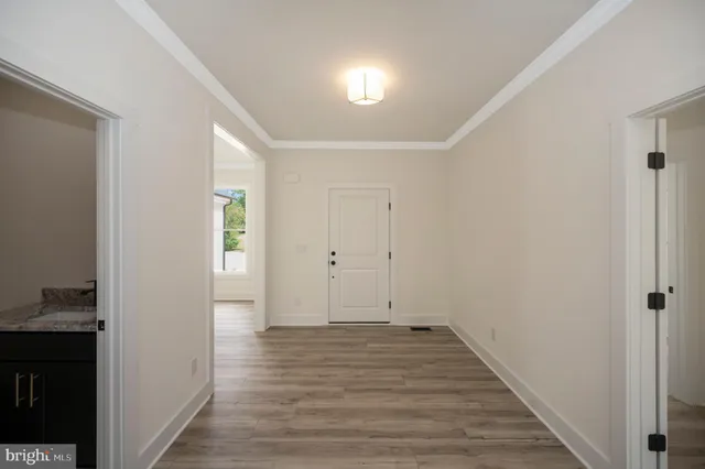 a view of a hallway with wooden floor