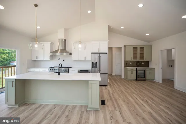 a view of kitchen view with stainless steel appliances refrigerator stove microwave and cabinets