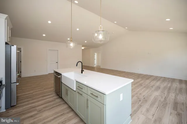 a kitchen with stainless steel appliances a stove a refrigerator and cabinets