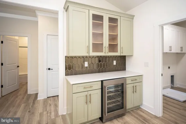 a kitchen with white cabinets and appliances