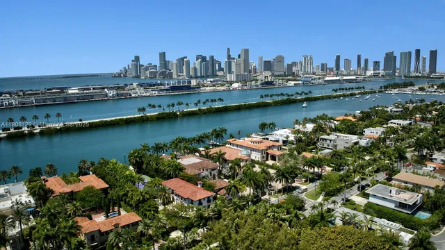 an aerial view of a city with lots of residential buildings lake and ocean view