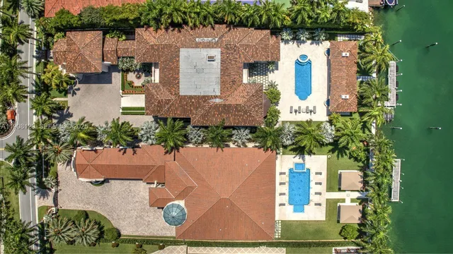 a front view of a house with a garden and trees