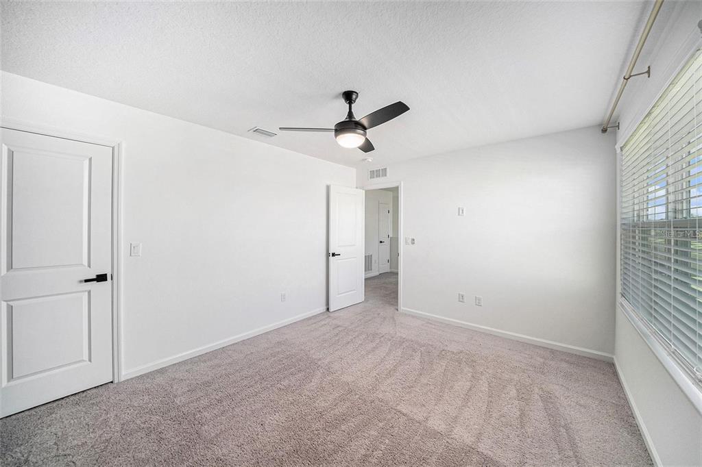 35542 Buttonweed Trail Zephyrhills, FL 33541 - Photo 13 of 30 a view of empty room with ceiling fan